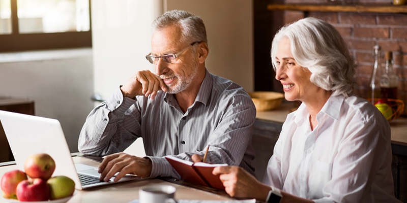 Elderly man and woman planning their trip
