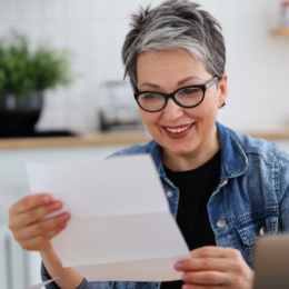 Older woman looking at tax refund paperwork