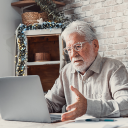 Senior man looking at his laptop concernedly 
