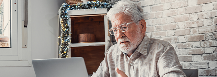 Senior man looking at his laptop concernedly 