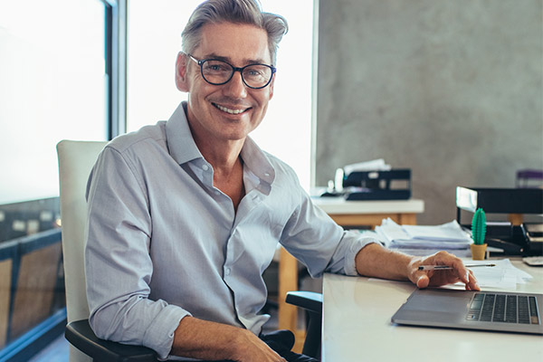 man sitting behind his computer