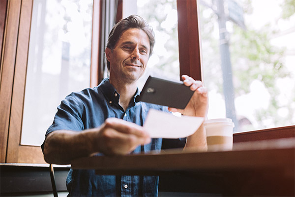 man making mobile deposit