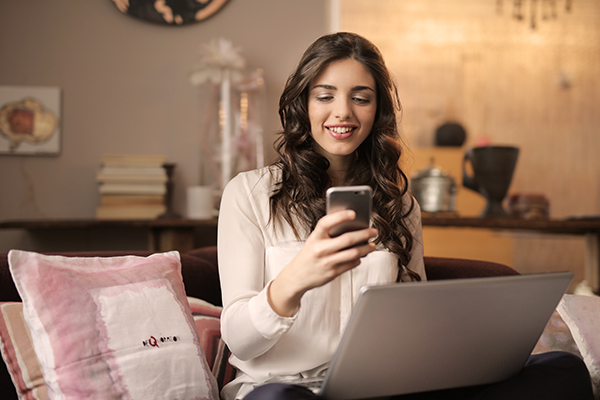 lady on her phone at the computer