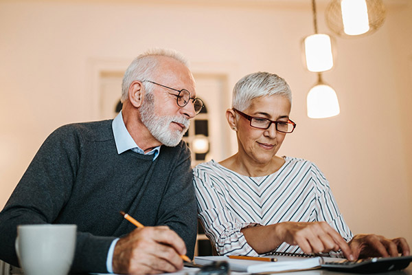 older couple paying bills